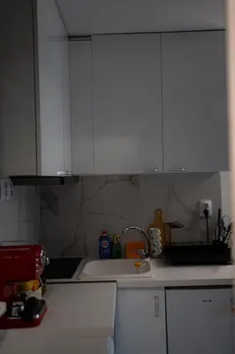 a kitchen with white cabinets and a sink at Comfy&Chick Central Apartment, Free Street Parking in Blagoevgrad