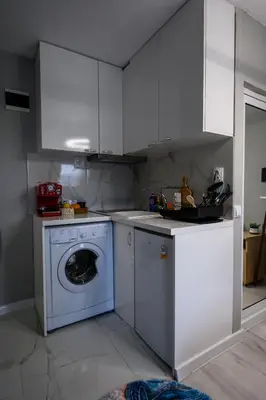 a kitchen with a washing machine and white cabinets at Comfy&Chick Central Apartment, Free Street Parking in Blagoevgrad
