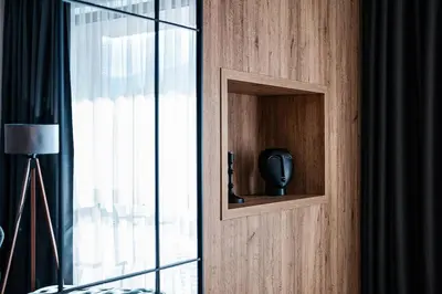 a wooden cabinet with a vase in it next to a window at Best Central LUX Studio in Bansko