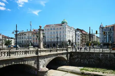 a bridge over a river in a city with buildings at Angels Loft opposite The Mall in Sofia