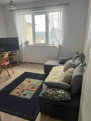 a living room with a couch and a chair at Angels Loft opposite The Mall in Sofia