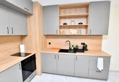 a kitchen with white cabinets and a sink at Contemporary Homes with Balcony in Sofia