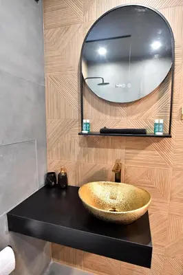 a bathroom with a bowl sink and a mirror at Contemporary Homes with Balcony in Sofia