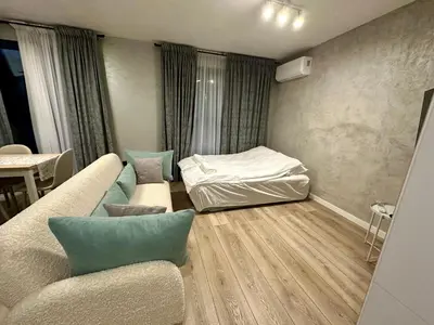 a living room with a couch and a bed at Casa Nova with Free Garage Parking in Plovdiv