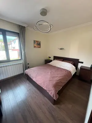 a bedroom with a bed and a large window at Pasarel House in Pasarel