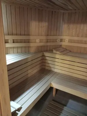 a wooden sauna with wooden benches in it at хотел София in Bansko