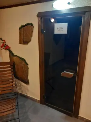 a door with a sign on it next to a wall at хотел София in Bansko