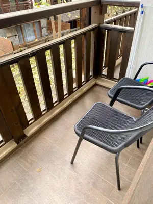 two chairs sitting on the balcony of a house at Luxury studio Perun Lodge in Bansko