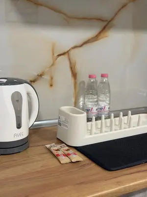 a coffee maker and bottles of water on a counter at Botev MiniHub Hub 2 Modern Studio at Botev 88 in Sofia