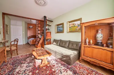 a living room with a couch and a table at Fabulous Retro Apartment in the Heart of Sofia in Sofia