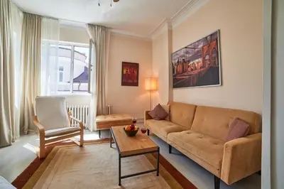 a living room with a couch and a chair at Heart of Sofia 2 Bdr Elevator Balcony Relax in Sofia