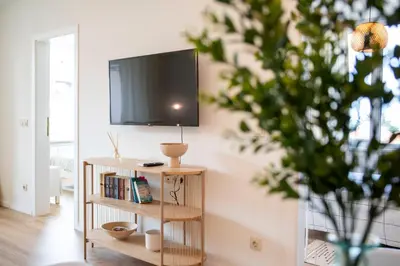 a television on a shelf in a living room at Mattea's 2-bedroom apartment in Sofia