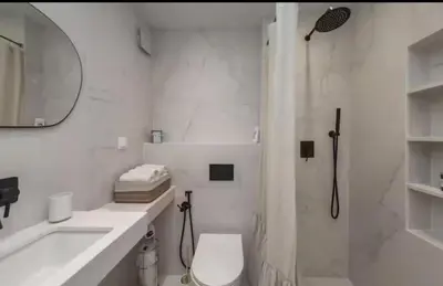 a bathroom with a shower and a toilet and a sink at Mattea's 2-bedroom apartment in Sofia