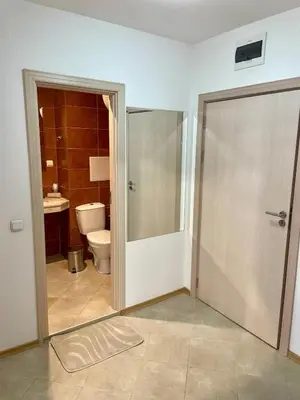 a bathroom with a toilet and a sliding glass door at Steps from Gondola Private Underground Parking by SI Stay in Bansko