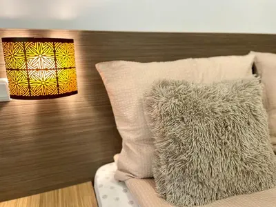 a bed with a pillow and a lamp at Steps from Gondola Private Underground Parking by SI Stay in Bansko