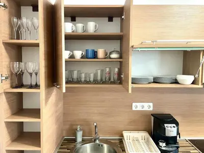 a kitchen with a sink and some plates and glasses at Steps from Gondola Private Underground Parking by SI Stay in Bansko