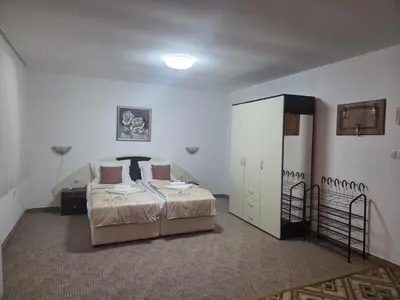 a bedroom with a bed and a closet in it at Апартамент Маунтин лодж in Pamporovo