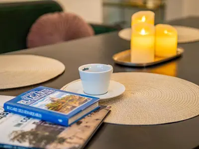 a book sitting on a table with a cup and a coffee cup at Central Sofia 2BR Apt City Center Historic in Sofia