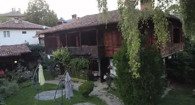 a house with ivy growing on the side of it at Мандулова Къща in Koprivshtitsa