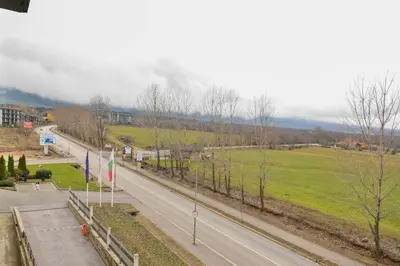an empty road with trees and a green field at Aspen Resort Studio Cozy & Fully Equipped by Flat Manаger in Bansko