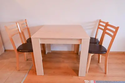 a wooden table with four chairs around it at Aspen Resort Studio Cozy & Fully Equipped by Flat Manаger in Bansko