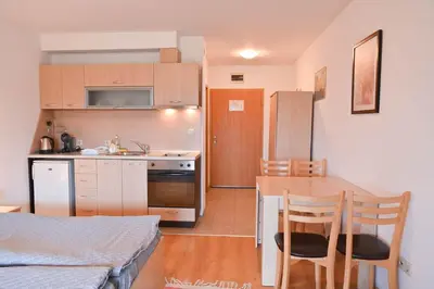 a kitchen and dining room with a table and a kitchen and a kitchen at Aspen Resort Studio Cozy & Fully Equipped by Flat Manаger in Bansko