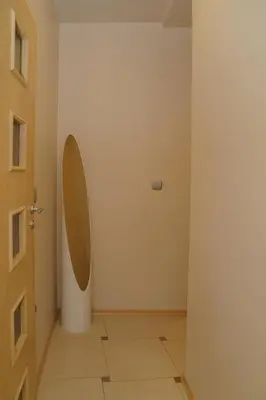 a hallway with a door and a wall with a mirror at South Park Cozy Flat in Sofia