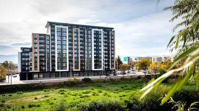 a tall apartment building with a park in front of it at ApArt by the river in Plovdiv