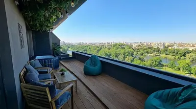 a balcony with chairs and a view of a river at ApArt by the river in Plovdiv