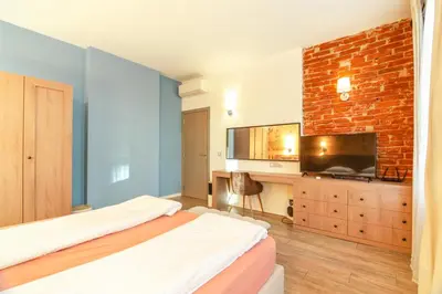 a bedroom with two beds and a brick wall at 1 BR Wine Journey in Sofia