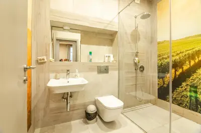 a bathroom with a toilet and a sink and a shower at 1 BR Wine Journey in Sofia
