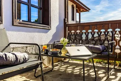 a laptop computer sitting on a table on a balcony at Vacation Home in Starosel Resort in Starosel