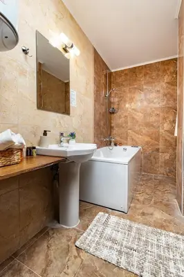 a bathroom with a sink and a bath tub at Vacation Home in Starosel Resort in Starosel