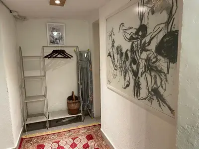 a hallway with a room with drawings on the wall at Social Apartment in Sofia