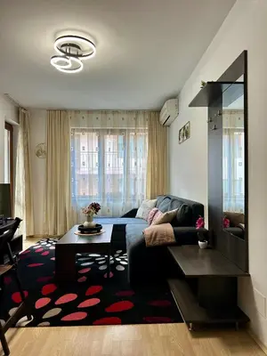 a living room with a couch and a table at Ski Apartment Bansko Home2Host in Bansko
