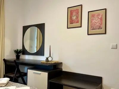 a room with a desk and a mirror on the wall at Ski Apartment Bansko Home2Host in Bansko