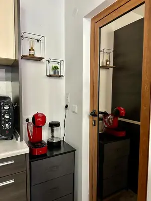 a kitchen with a door open to a kitchen with a blender at Ski Apartment Bansko Home2Host in Bansko