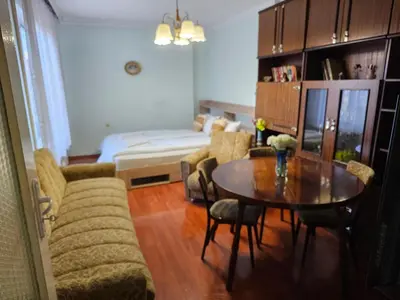 a living room with a table and a couch at Affordable 3BR near Centre in Sofia