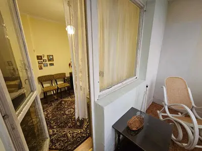 a room with a window and a table and chairs at Affordable 3BR near Centre in Sofia