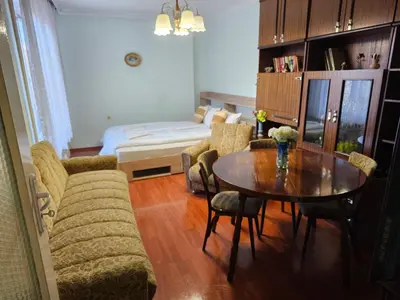 a living room with a table and a couch at Affordable 3BR near Centre in Sofia