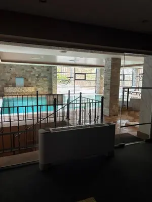 a view of a swimming pool from inside a building at Chamkoria Borovets luxury apartment view in Borovets