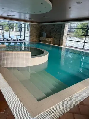 a large swimming pool in a building at Chamkoria Borovets luxury apartment view in Borovets