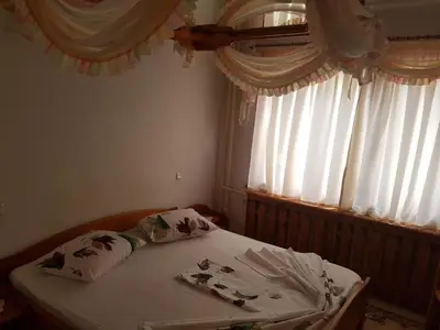 a bed in a bedroom with a window at Hotel Mishel in Kocherinovo