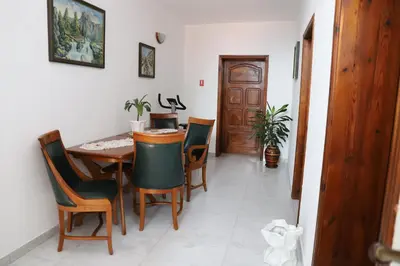a dining room with a wooden table and chairs at Hotel Mishel in Kocherinovo