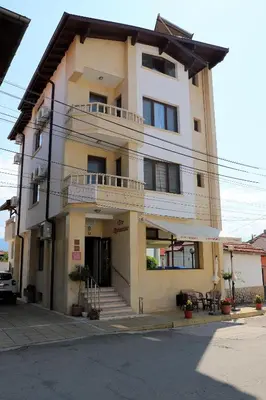 a large white building with a balcony on a street at Hotel Mishel in Kocherinovo