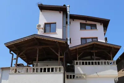 a building with wooden balconies on top of it at Hotel Mishel in Kocherinovo