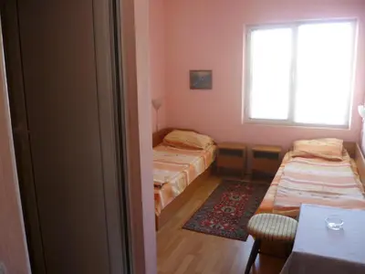 a small room with two beds and a window at Stai Za Gosti Venera in Hisarya