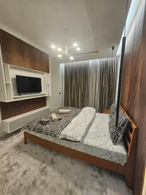 a bedroom with a bed and a television in a room at Luxury Forest Apartment in Borovets