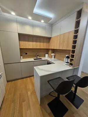 a kitchen with a counter and a chair and a sink at Luxury Forest Apartment in Borovets