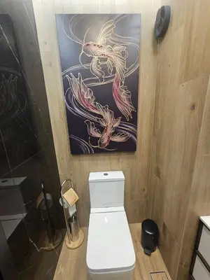 a bathroom with a toilet and a painting on the wall at Luxury Forest Apartment in Borovets